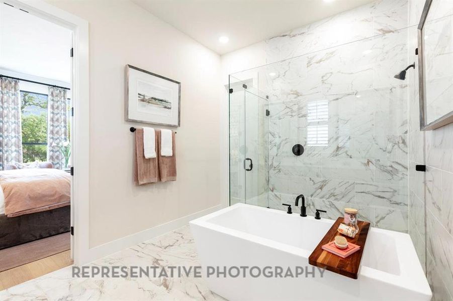 Bathroom featuring light marble finish flooring, a freestanding bath, ensuite bath, a marble finish shower, and recessed lighting Bathroom featuring light marble finish flooring, a freestanding bath, ensuite bath, a marble finish shower, and recessed lighting