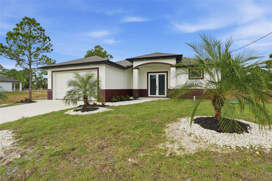 Front exterior of a new home in , Lehigh Acres, FL, highlighting curb appeal (Image 17).