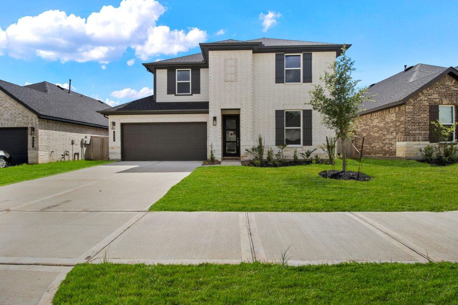 Front exterior of a new home in Hills of Westlake, Conroe, TX, highlighting curb appeal (Image 1). Front exterior of a new home in Hills of Westlake, Conroe, TX, highlighting curb appeal (Image 1).