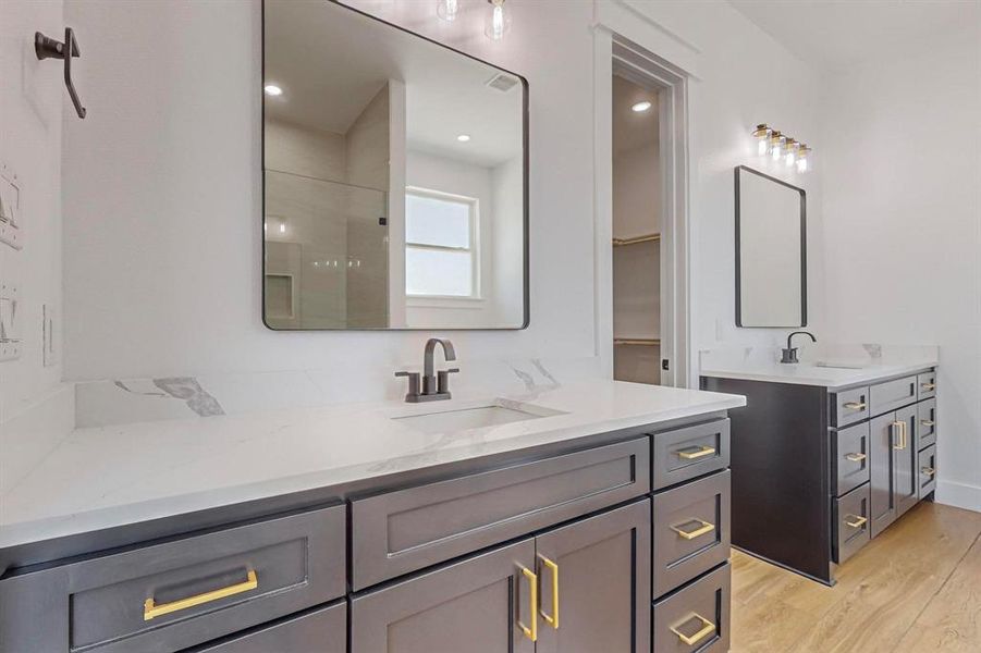 Bathroom featuring double vanity and hardwood / wood-style flooring