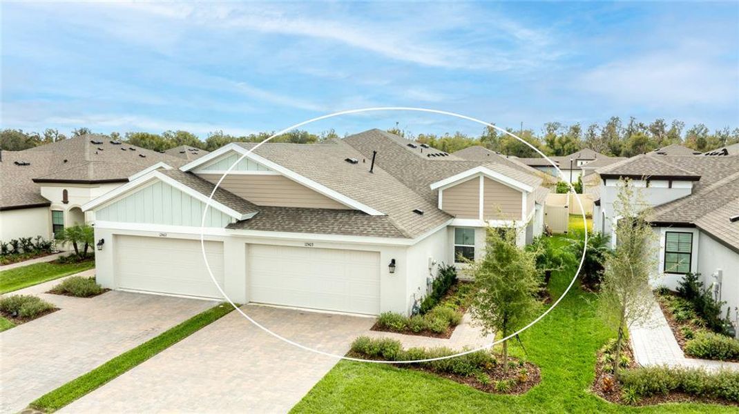 Front exterior of a new home in Crosswind Point, Parrish, FL, highlighting curb appeal (Image 20).