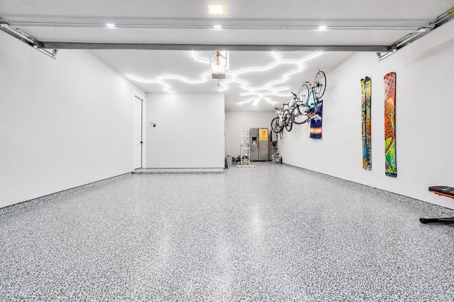 3 car tandem garage finished with epoxy and honeycomb lighting.