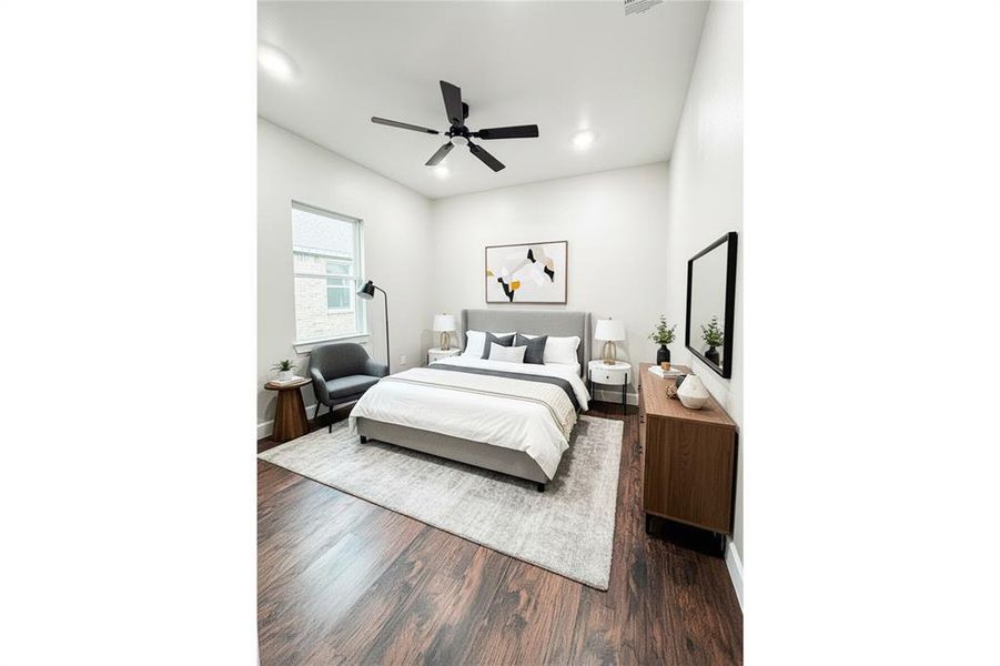 Bedroom featuring dark wood-style flooring, a ceiling fan, and recessed lighting Bedroom featuring dark wood-style flooring, a ceiling fan, and recessed lighting
