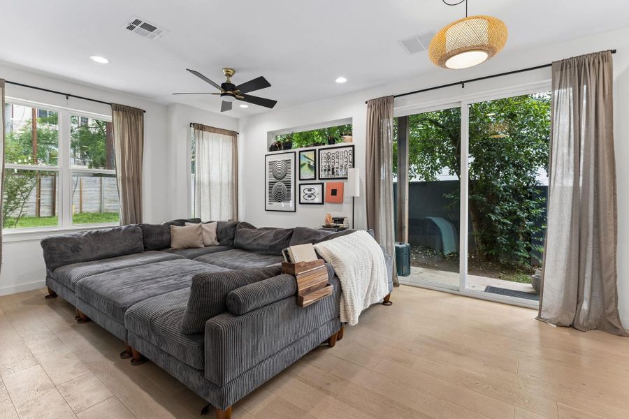 A secondary bedroom that maintains the home's bright aesthetic. This versatile space is perfect for a guest room, nursery, or a dedicated home office, complete with a generous closet and large windows.