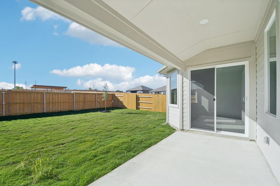 Fenced backyard featuring a patio