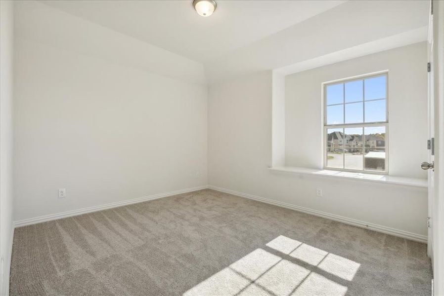 Empty room featuring light carpet