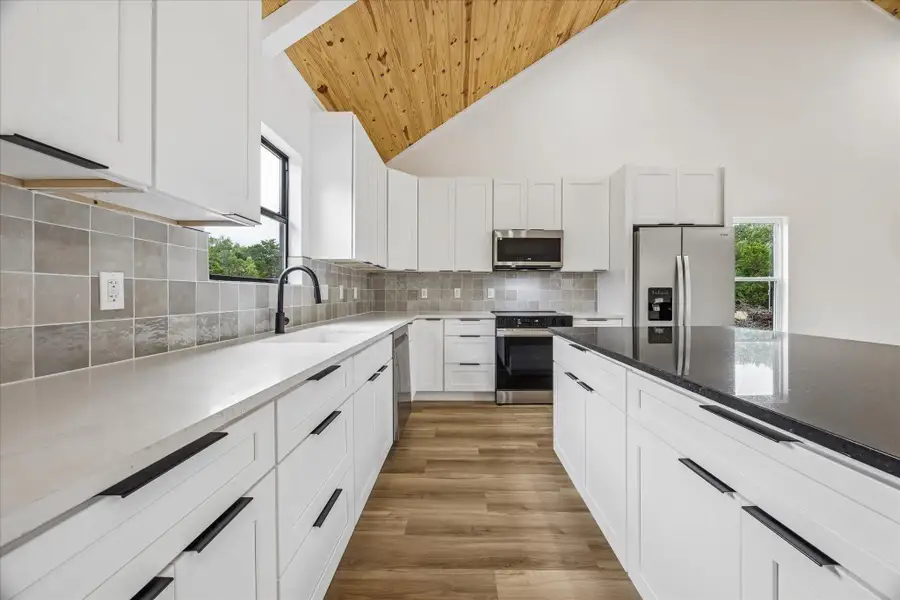 Culinary dreams come alive in this kitchen, featuring soaring vaulted ceilings and abundant counter space. Culinary dreams come alive in this kitchen, featuring soaring vaulted ceilings and abundant counter space.