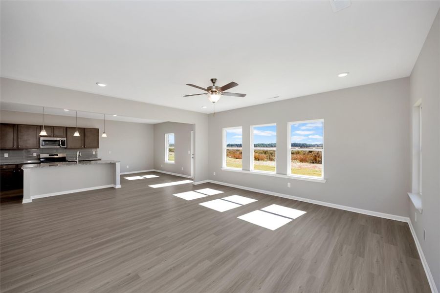 The Harrington- Family Room into the kitchen and breakfast area. Sample image for illustration; upgrades, options, and colors may vary. The Harrington- Family Room into the kitchen and breakfast area. Sample image for illustration; upgrades, options, and colors may vary.