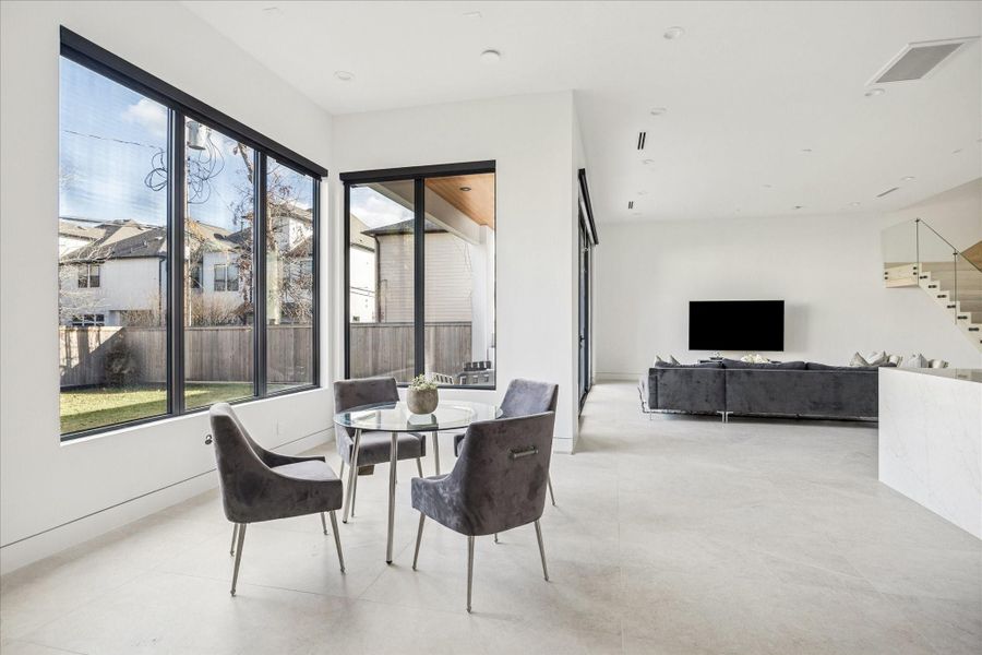 The dining space provides views of the backyard and easy access to the covered patio.