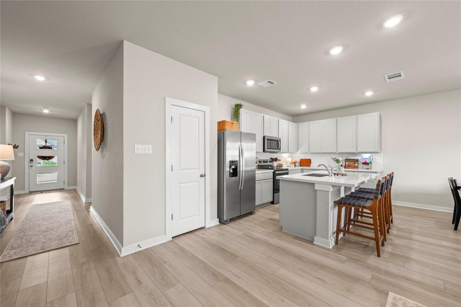Seamlessly integrating a functional kitchen island with a welcoming entry, this space offers effortless living. Seamlessly integrating a functional kitchen island with a welcoming entry, this space offers effortless living.