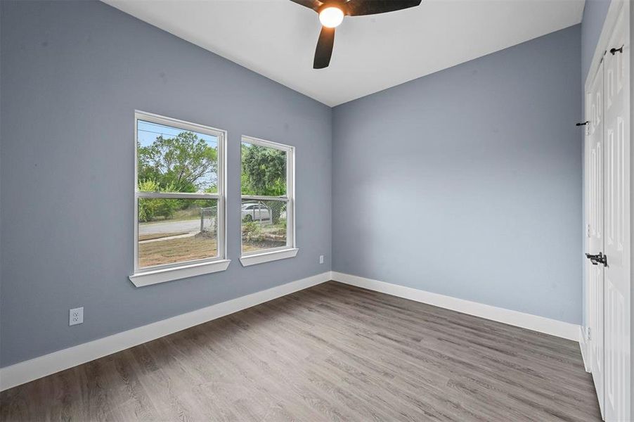 Empty room featuring wood-type flooring and ceiling fan