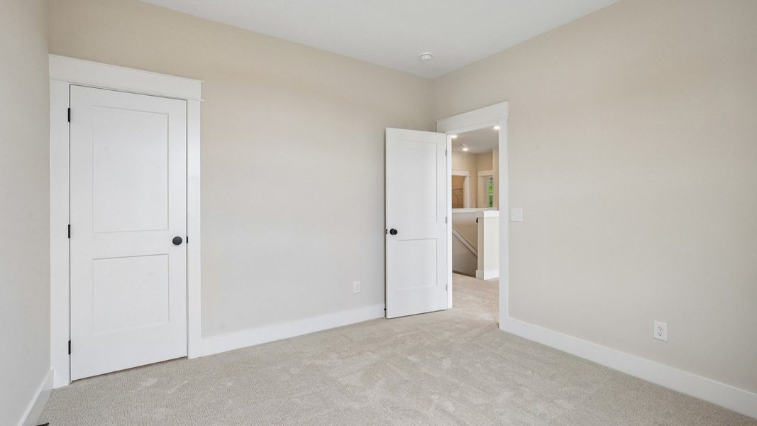 Bedroom with carpet and closet Bedroom with carpet and closet