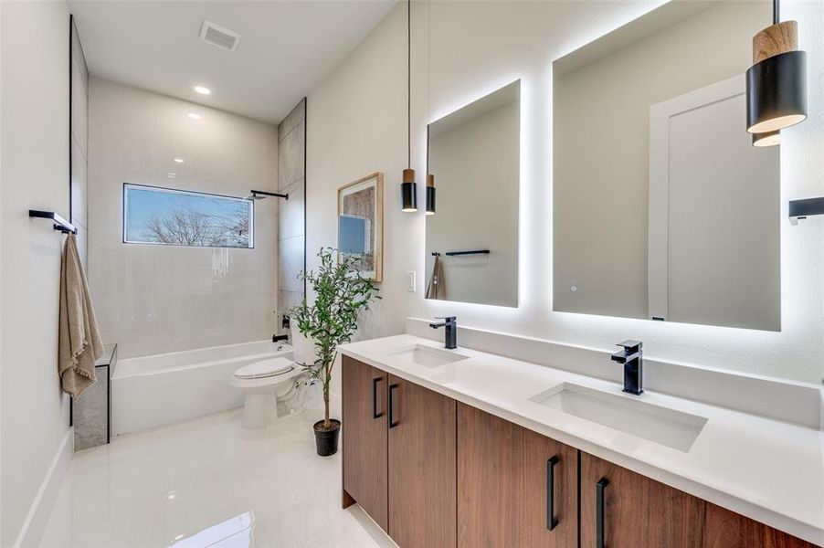 Dual vanity with under-mount sinks, wood-finish cabinetry, and matte black fixtures