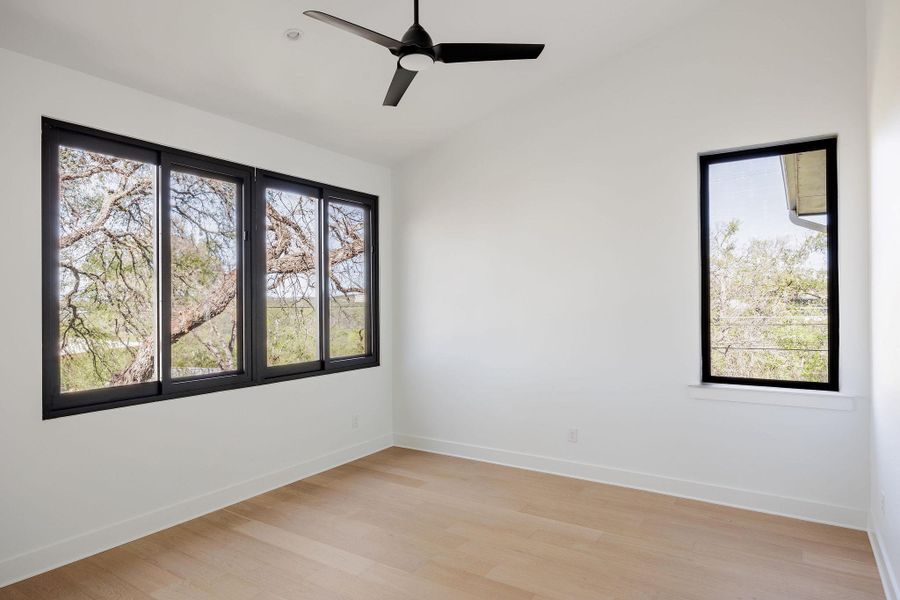A secondary bedroom provides a comfortable and flexible space, finished with wide-plank oak flooring and soft natural light. A secondary bedroom provides a comfortable and flexible space, finished with wide-plank oak flooring and soft natural light.