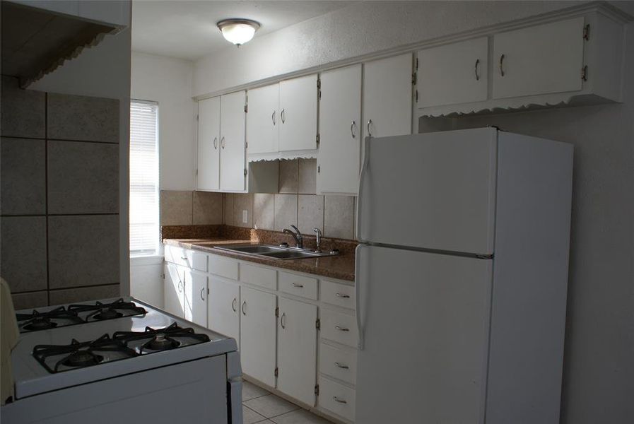Cozy kitchen with lots of cabinets and a floor to ceiling pantry. Gas stove and refrigerator included.