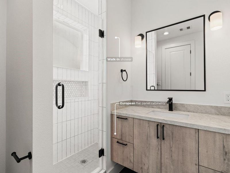 The ensuite bath features a floating vanity with ample storage and a walk-in shower with designer tile accents.