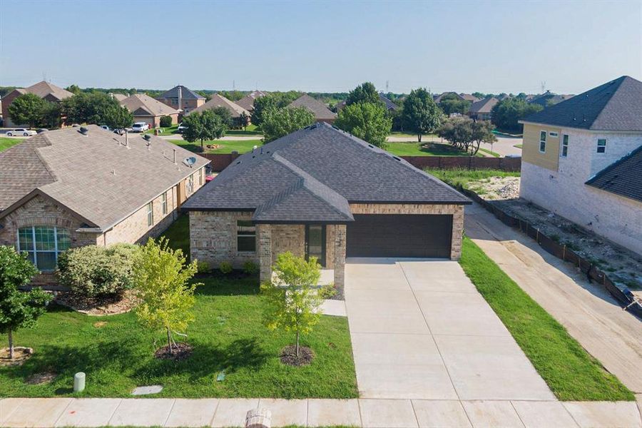 View of front of home with a front lawn and a garage