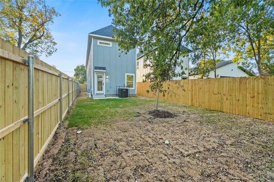 Back of house featuring a fenced backyard, board and batten siding, and a shingled roof Back of house featuring a fenced backyard, board and batten siding, and a shingled roof