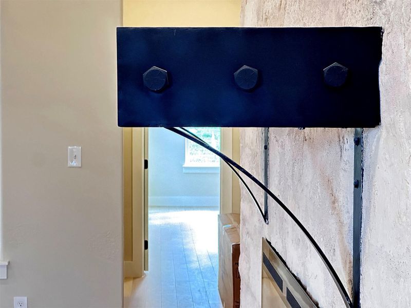 detail view of custom iron end cap of fireplace mantle