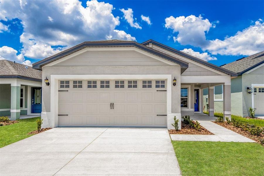 Front exterior of a new home in Gum Lake Preserve, Lake Alfred, FL, highlighting curb appeal (Image 14). Front exterior of a new home in Gum Lake Preserve, Lake Alfred, FL, highlighting curb appeal (Image 14).