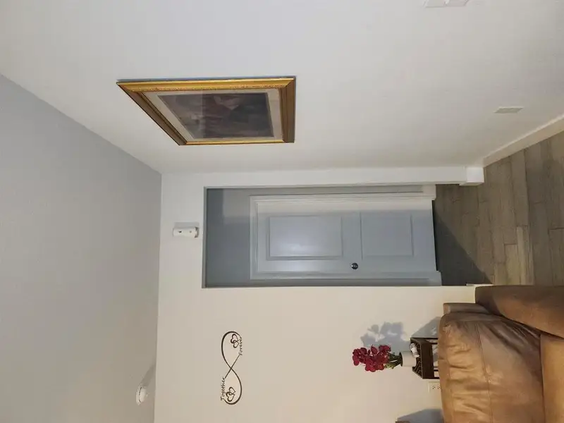 Hallway with wood finished floors and baseboards