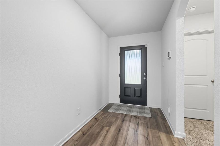 Entrance foyer with dark wood-type flooring