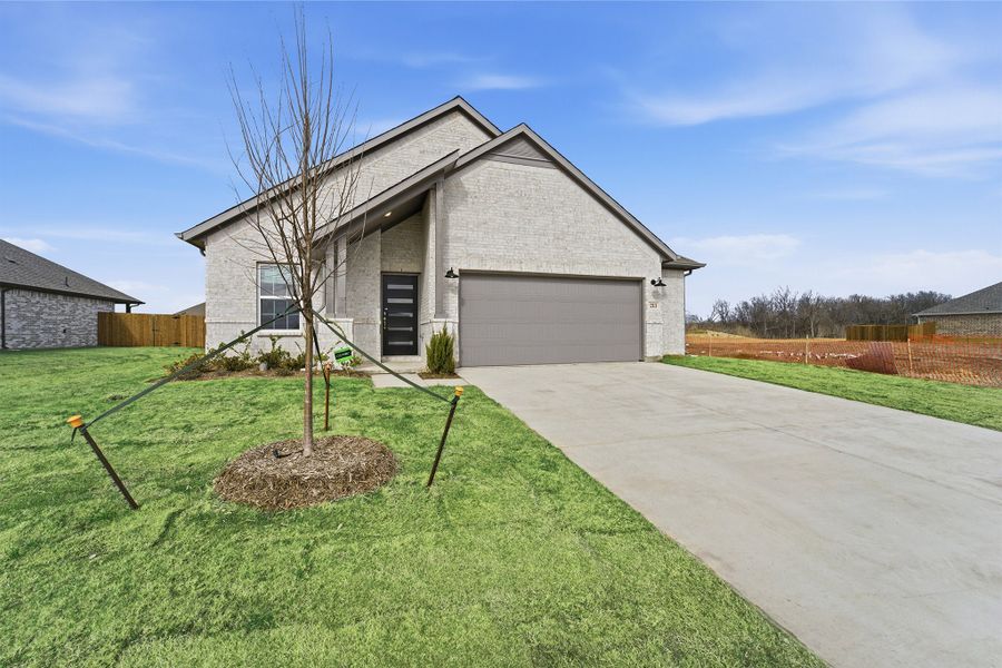 Front exterior of a new home in Saddlebrook Estates, Waxahachie, TX, highlighting curb appeal (Image 2). Front exterior of a new home in Saddlebrook Estates, Waxahachie, TX, highlighting curb appeal (Image 2).