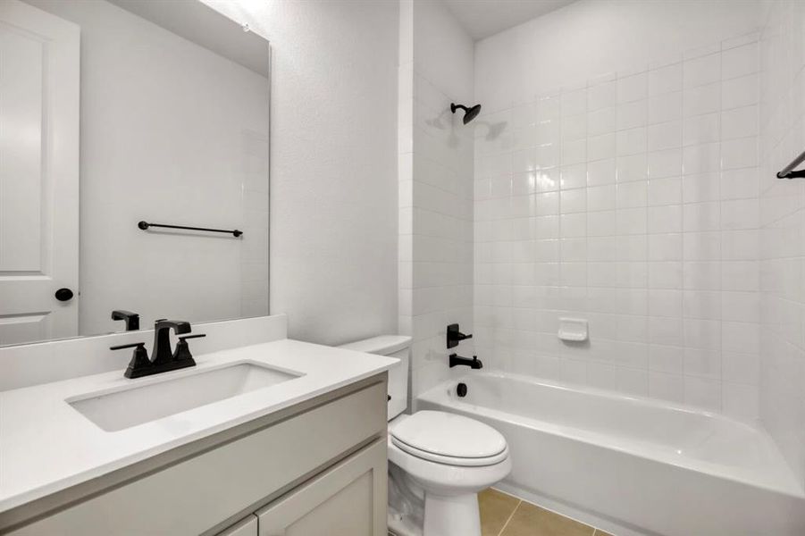 Full bathroom featuring vanity, bathtub / shower combination, and light tile patterned floors