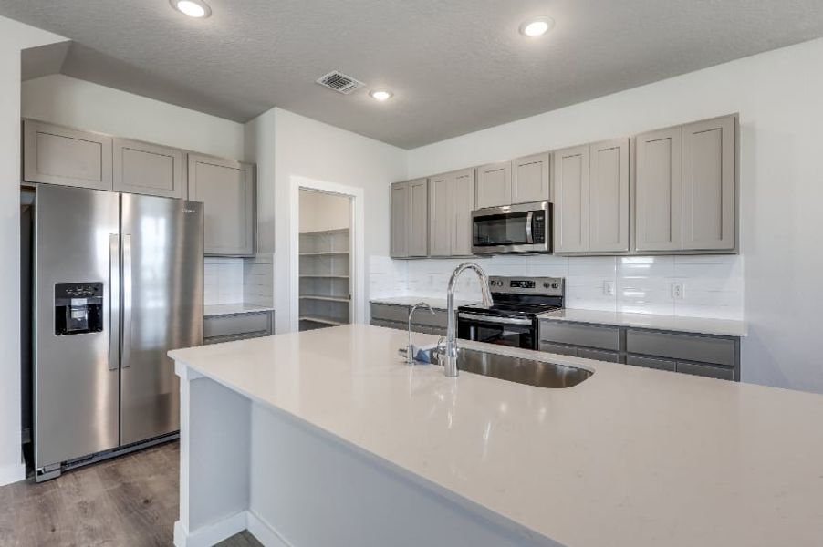 A kitchen with white cabinets. A kitchen with white cabinets.