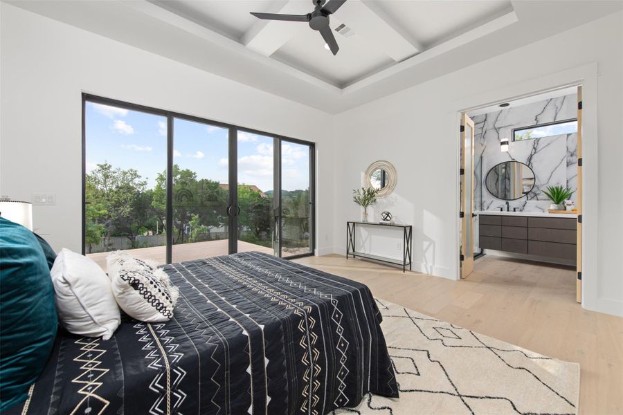 Photo is similar to home being built.  Ensuite bathroom, hard wood floors, and coffered ceiling