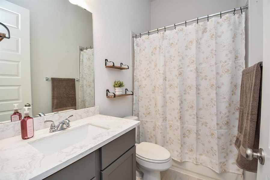 Chic Full Bath: Modern finishes, elegant marble vanity, and sleek fixtures create a tranquil spa-like retreat.