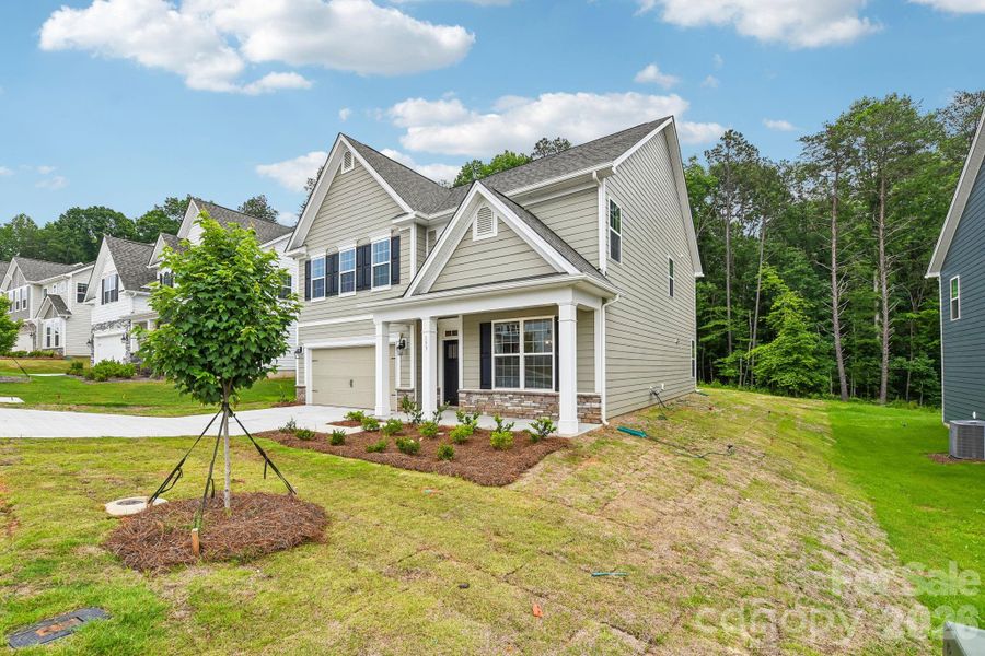 Front exterior of a new home in Falls Cove, Troutman, NC, highlighting curb appeal (Image 1). Front exterior of a new home in Falls Cove, Troutman, NC, highlighting curb appeal (Image 1).