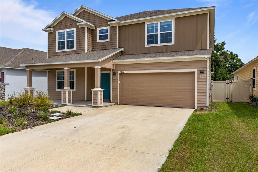 Front exterior of a new home in Avalon Woods, Newberry, FL, highlighting curb appeal (Image 23).