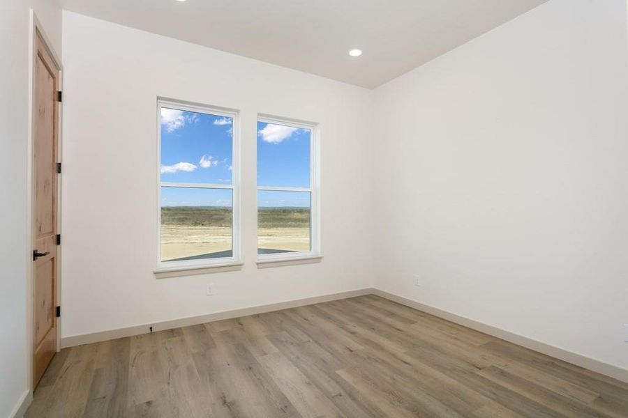 Spare room featuring light wood-type flooring and recessed lighting Spare room featuring light wood-type flooring and recessed lighting