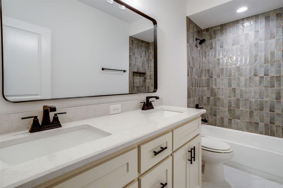 Bathroom with double vanity and tub / shower combination