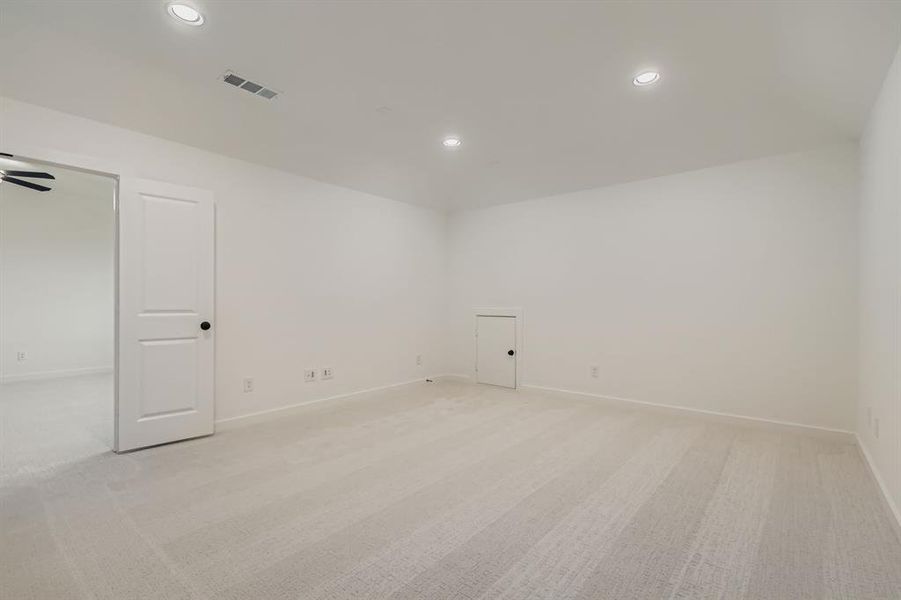 Empty room with light carpet and recessed lighting Empty room with light carpet and recessed lighting