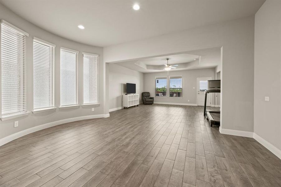 Bright open layout connecting the living room, dining, and kitchen, with large windows bringing in natural light.