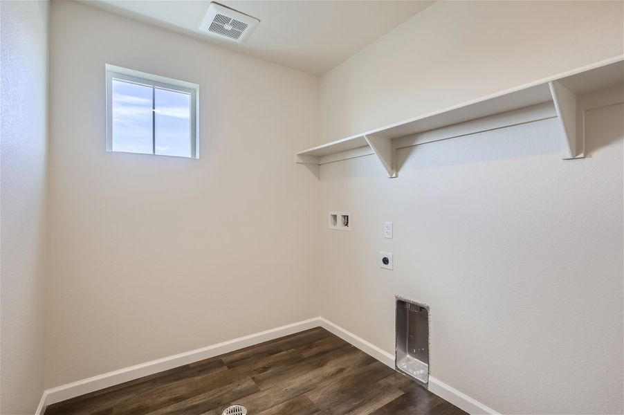 A room with a wood floor and a window. A room with a wood floor and a window.