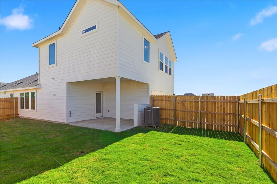 Rear view of property featuring a patio area and a fenced backyard