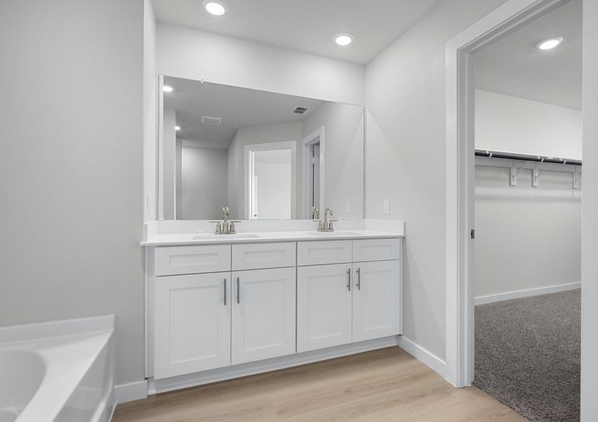 Master bath has a double-sink vanity and connects to a large walk-in closet. Master bath has a double-sink vanity and connects to a large walk-in closet.