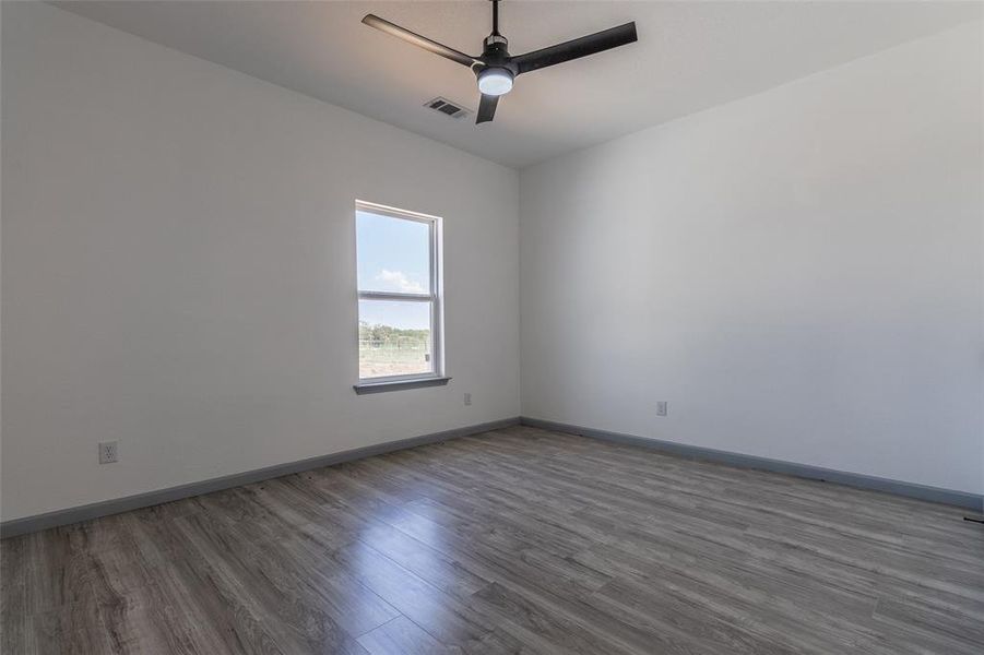 Unfurnished room featuring ceiling fan and wood-type flooring