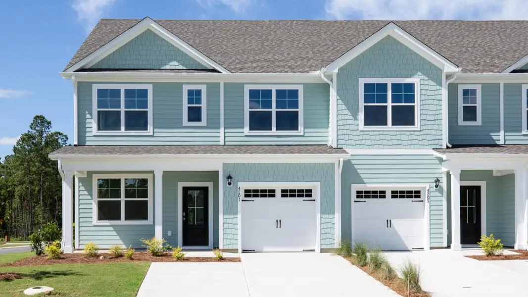 Front exterior of a new home in Indigo Preserve Townhomes, Leland, NC, highlighting curb appeal (Image 1).
