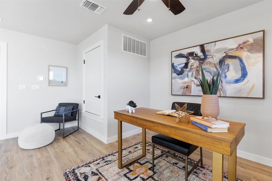 Office area with a ceiling fan, light wood finished floors, and recessed lighting