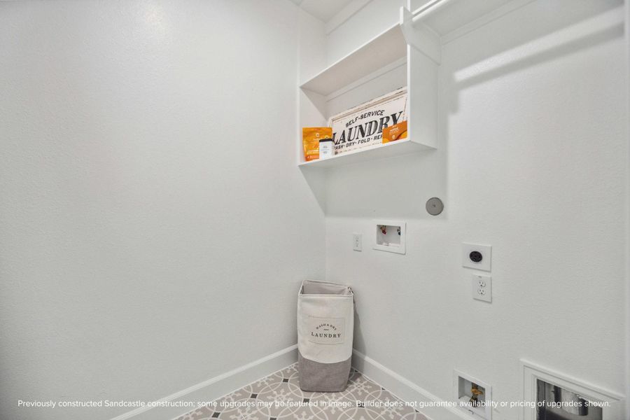 Clean design meets clever function in this dedicated laundry room. With built-in shelving and plenty of space to fold, it actually makes chores feel…doable.