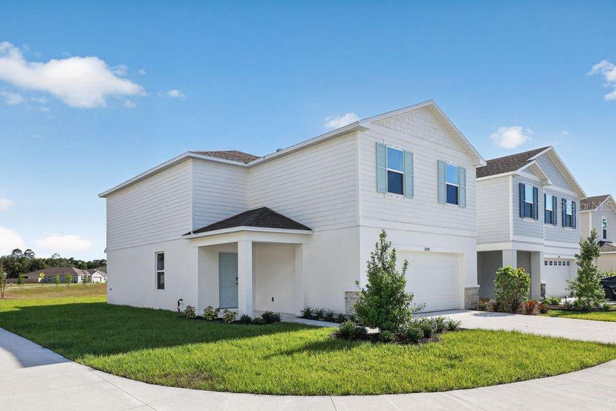 Front exterior of a new home in Palm Wind, Hudson, FL, highlighting curb appeal (Image 21).