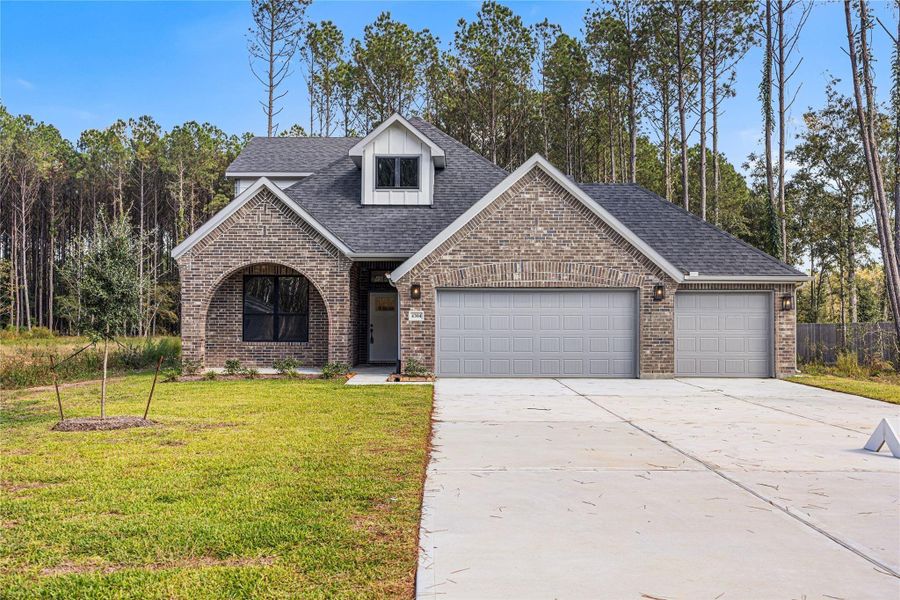 Front exterior of a new home in Encino Estates, Dayton, TX, highlighting curb appeal (Image 2). Front exterior of a new home in Encino Estates, Dayton, TX, highlighting curb appeal (Image 2).