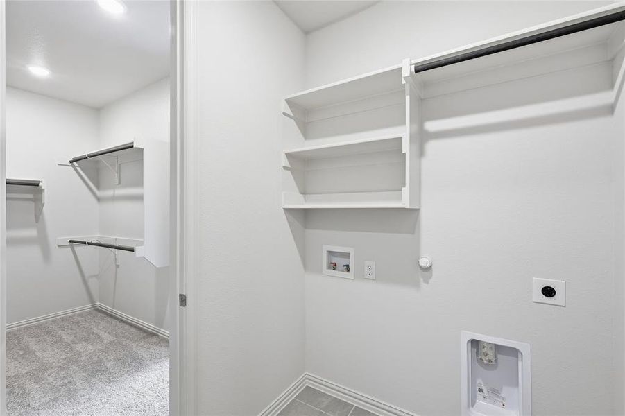 Washroom with hookup for a gas dryer, electric dryer hookup, hookup for a washing machine, and light colored carpet Washroom with hookup for a gas dryer, electric dryer hookup, hookup for a washing machine, and light colored carpet