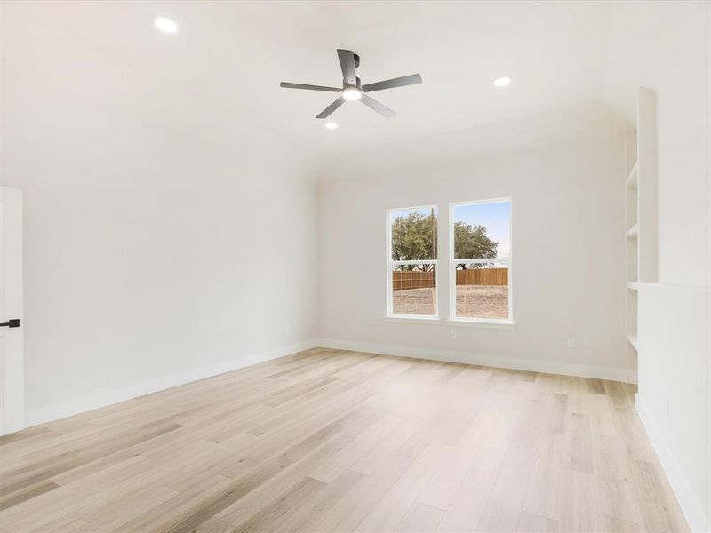 Spare room with light wood-type flooring, ceiling fan, and recessed lighting
