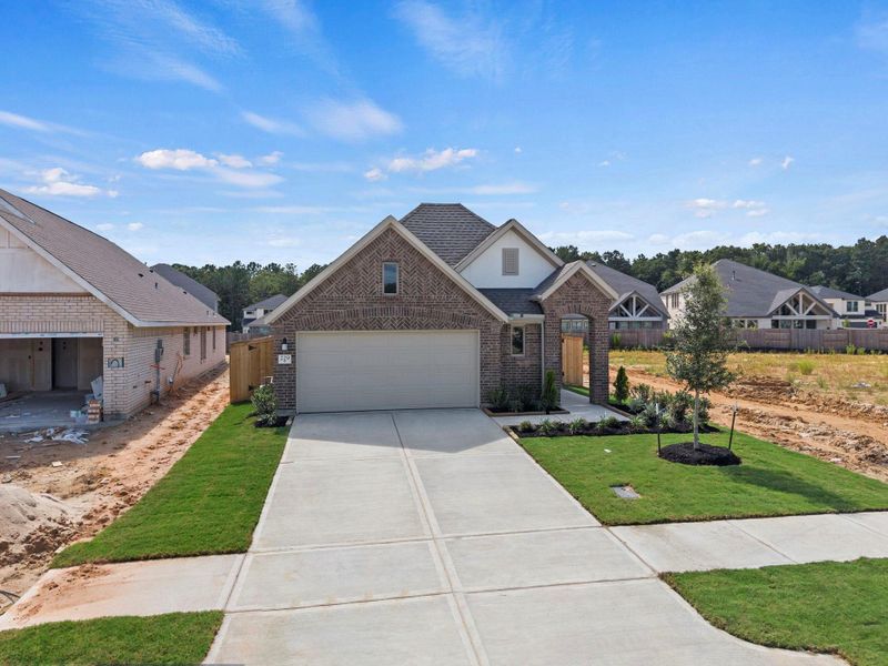 Front exterior of a new home in The Trails, New Caney, TX, highlighting curb appeal (Image 20). Front exterior of a new home in The Trails, New Caney, TX, highlighting curb appeal (Image 20).
