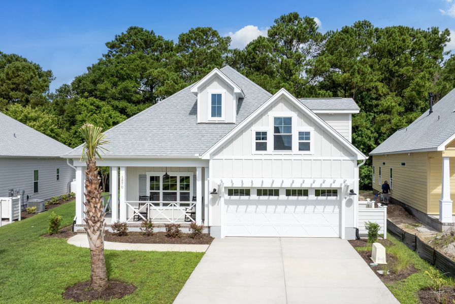 Front exterior of a new home in The Sanctuary at Sunset Beach, Sunset Beach, NC, highlighting curb appeal (Image 1).